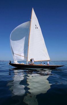 a sailboat with people on it in the water