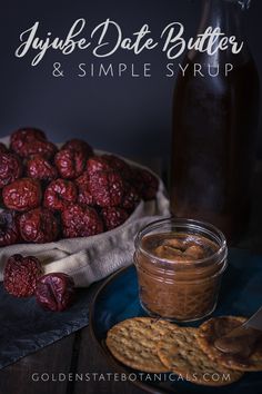 a plate with crackers and jam next to a bowl of cookies on a table