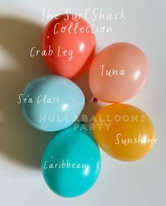 four balloons with names on them sitting in the middle of a white tablecloth that says, the surf shack collection crab leg tuna sea glass hull balloon party sunshine