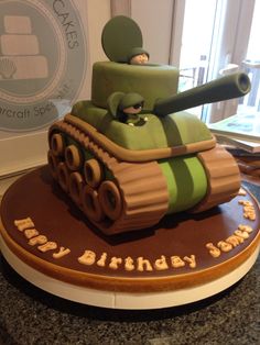 a birthday cake made to look like a tank with an army man sitting on top