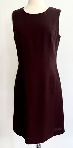 Vintage 90's Henri Bendel New York chocolate brown sleeveless dress with original tags still attached Fully lined and closes with zipper along the back No care label but fabric feels like a light wool blend Marked size 6 and seems to fit in the ballpark of a modern XS/S.  Photographed on a size 2/4 dress form.  Please use measurements to ensure a proper fit. Measurements (zipped & laying flat): Pit-to-pit: 18" Waist: 15-3/4" Hips: 18" Top of shoulder-to-hem: 36-1/4" Good vintage condition.  Please note the Henri Bendel label has a red mark on it - likely because the garment was put on sale.  On the bag of the label, it is written $79 A NOTE ABOUT MY CLOTHING LISTINGS: I'm very picky when it comes to cut and style so you can rest assured my vintage garments will be WEARABLE mixed in with yo Formal Brown Fitted Mini Dress, Formal Fitted Brown Mini Dress, Fitted Brown A-line Sleeveless Dress, Chic Fitted Brown Sleeveless Dress, Formal Brown Lined Dress, Elegant Brown Fitted Sleeveless Dress, Elegant Fitted Brown Sleeveless Dress, Brown Fitted Sleeveless Dress For Work, Fitted Sleeveless Brown Dress