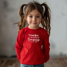 Toddler snacks are my  love Language shirt, Love Language shirt, Kids cheese Lover shirt, Toddler long sleeved cheese tee, funny kids shirt, toddler snacks shirt, snack lover love language sweatshirt, finicky eater tee, picky eater shirt, Toddler Valentines Day outfit, Kids Valentines Day shirt Hi! Welcome to my Blue Allegory! I'm delighted to see you here.  Please contact me if you have any questions or want to order a custom made product.  I hope you'll love my designs. 🥰 Designed to bring the best to the youngest of us all, the custom toddler long-sleeve tee is made from 100% combed ringspun cotton fine jersey. Built to last, the garment features a topstitched ribbed collar and shoulder-to-shoulder self-fabric back-neck taping. These inclusions boost durability, fit, and comfort. The l Cute Long Sleeve Birthday Shirt, Fun Long Sleeve Tops For Birthday, Cute Long Sleeve Shirt With Funny Print, Funny Long Sleeve Tops With Text Print, Casual Long Sleeve T-shirt With Funny Text, Funny Long Sleeve Tops With Graphic Print, Funny Long Sleeve T-shirt With Text, Long Sleeve Pre-shrunk T-shirt As Gift, Pre-shrunk Long Sleeve T-shirt As A Gift