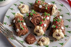 a plate topped with chocolate desserts on top of a white and green table cloth