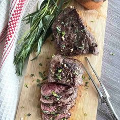 steak with herbs and potatoes on a cutting board