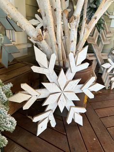 a wooden snowflake sitting on top of a wooden deck