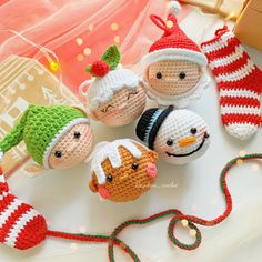 crocheted christmas ornaments are displayed on a table