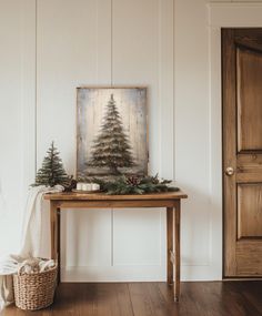 a wooden table topped with a christmas tree next to a basket filled with pine cones