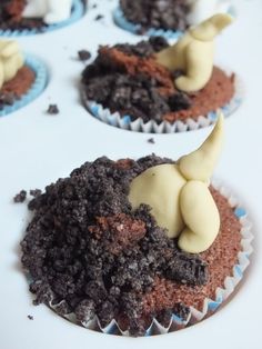 chocolate cupcakes with white frosting and an elephant on top