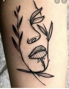 a woman's face with leaves on her leg