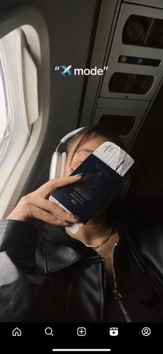 a woman is reading a book while sitting in an airplane with her head on the seat