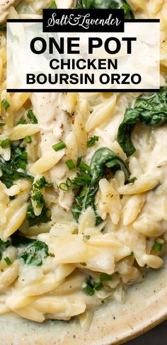 a bowl filled with pasta and spinach on top of a table