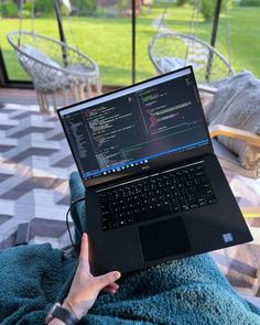 a person sitting in a chair with a laptop on their lap