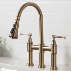 two faucets on a kitchen counter top with white tiles in the back ground