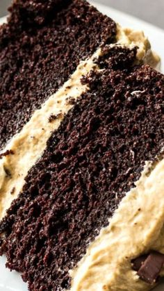 a slice of chocolate cake with peanut butter frosting on a white plate, ready to be eaten