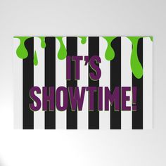 it's showtime sticker on a white wall next to a black and green striped background