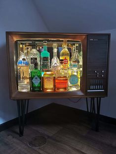 an old fashioned liquor cooler with bottles on it's sides and lights in the front