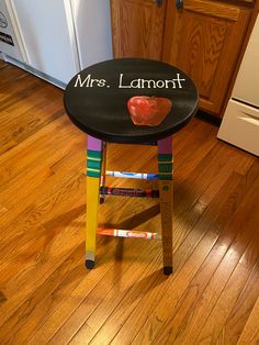 a child's stool with the words mrs lamont painted on it in front of a refrigerator