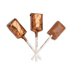 three caramel lollipops on a white background