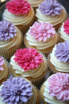 there are many cupcakes with flowers on them