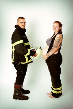 a man and woman dressed in fire fighter gear