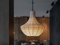 a light fixture hanging from the ceiling in a restaurant