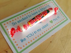 a candy bar is sitting on top of a card that says, so excited to have a share like you in my class