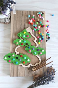 decorated cookies are sitting on a cutting board