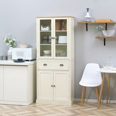 a white cabinet sitting next to a small table