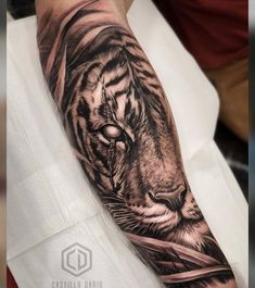 a man with a tiger tattoo on his arm