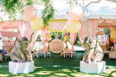 an outdoor party with balloons and decorations