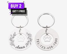 two personalized key chains with the name and dog's paw on them