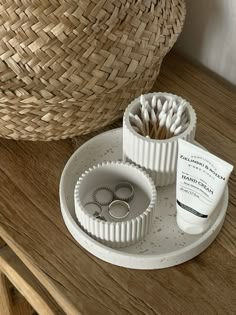 two wedding rings are placed on a tray next to some toothbrushes and other items