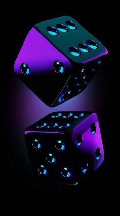 two black and purple dices with blue lights on them are shown in the dark