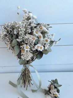 a bouquet of flowers sitting on top of a white table next to a pair of scissors