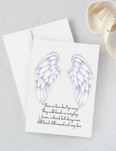 a card with two angel wings on it