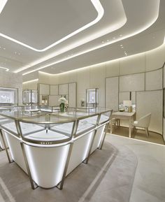 the interior of a jewelry store with glass counter tops and white lighting on the ceiling