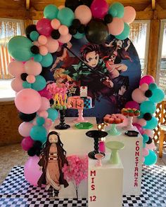 a table topped with lots of balloons and cake