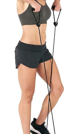 a woman in black shorts and grey tank top holding a pair of exercise ropes