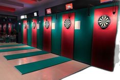 the darts are lined up on the wall in the room with red and green walls