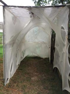 an outdoor structure with white fabric covering it