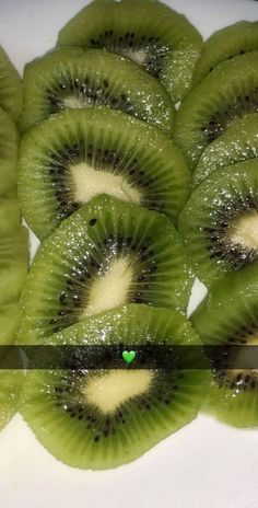 sliced kiwis sitting on top of a white plate