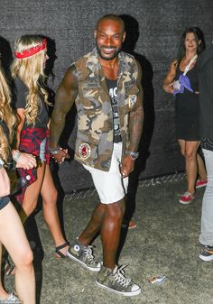 Looking good: Model Tyson Beckford sported a sleeveless military jacket over a Ramones ves... Celebrity Style Men, Black Man White Girl, Beard Fashion, Camouflage Fashion, Tiny Shorts, Issa Vibe, California Desert