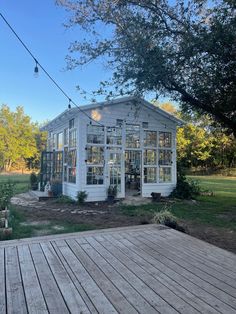 a white house sitting on top of a wooden deck