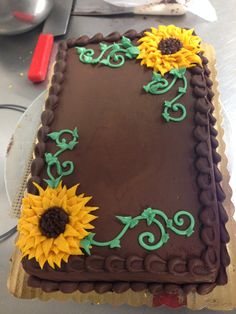 a chocolate cake with sunflowers on it