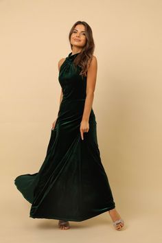 a woman in a green dress posing for the camera