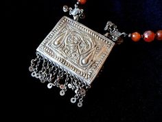 "This is an old tribal necklace. I have had it for a long time and believe it is a tribal piece that is Bedouin It has carnelian with red glass and is spectacular. It is hand embossed with accents and both sides are embossed. It is ethnic and Arab. Size: The pendant is 2 1/2\" x 2\" long and the chain is 28\" Condition: Excellent condition- (see all photos) SHIPPING: Priorty shipping is $5.35" Vintage Ceremonial Jewelry With Silver Beads, Bedouin Jewelry, Amazigh Jewelry, Antique Carnelian Beaded Necklace, Moroccan Amazigh Jewelry, 1940s Jewelry, Red Glass, Drop Earrings, Chain