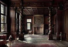 an old fashioned living room with wood paneling