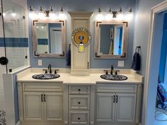 a bathroom with two sinks and mirrors in it