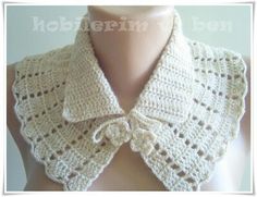 a white crocheted collar on top of a mannequin