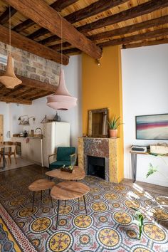 a living room filled with furniture and a fire place in the middle of a room